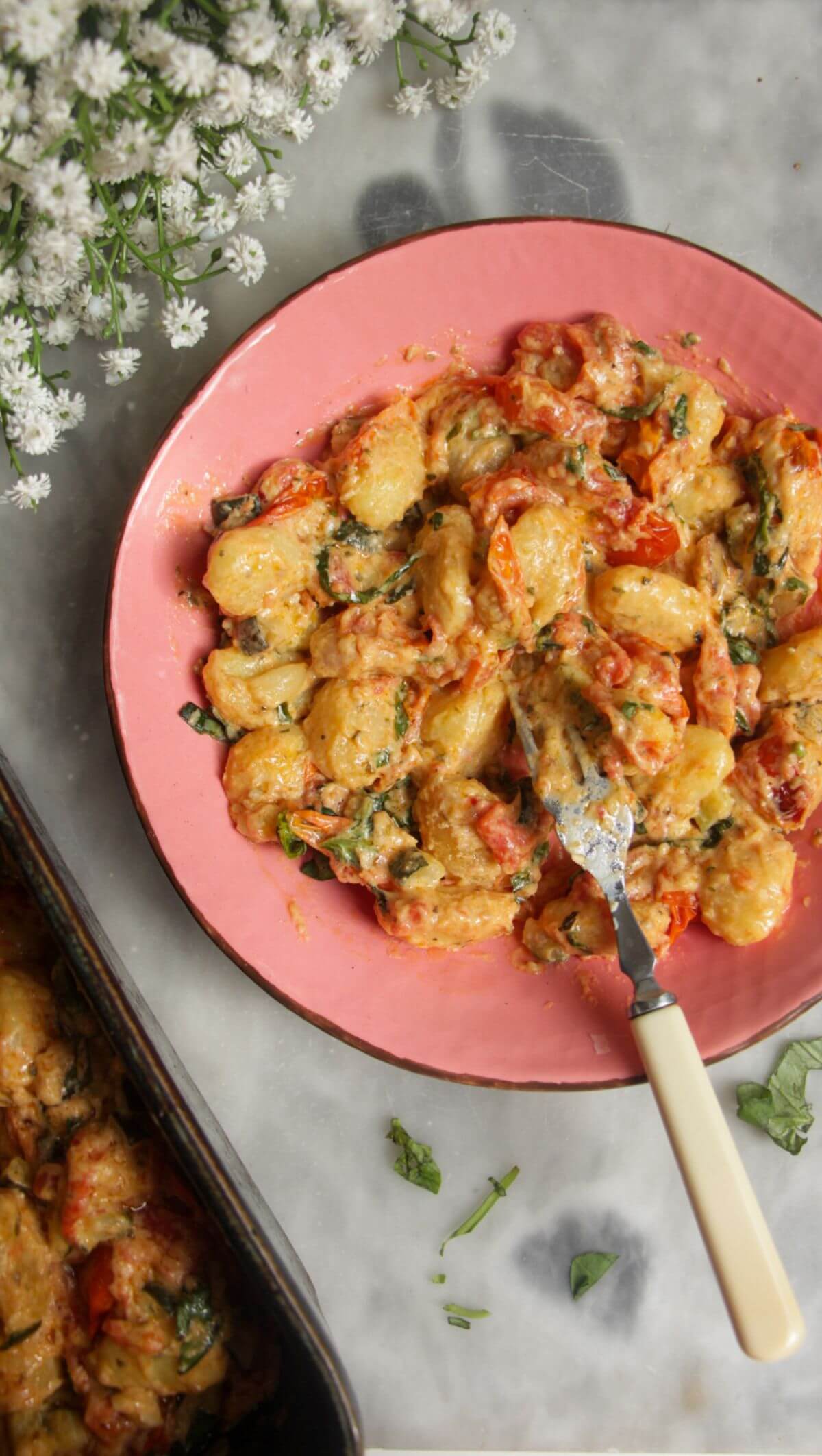 Creamy Boursin gnocchi in a pink bowl.