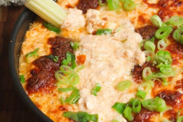 Buffalo chicken dip baked and topped with scallions.