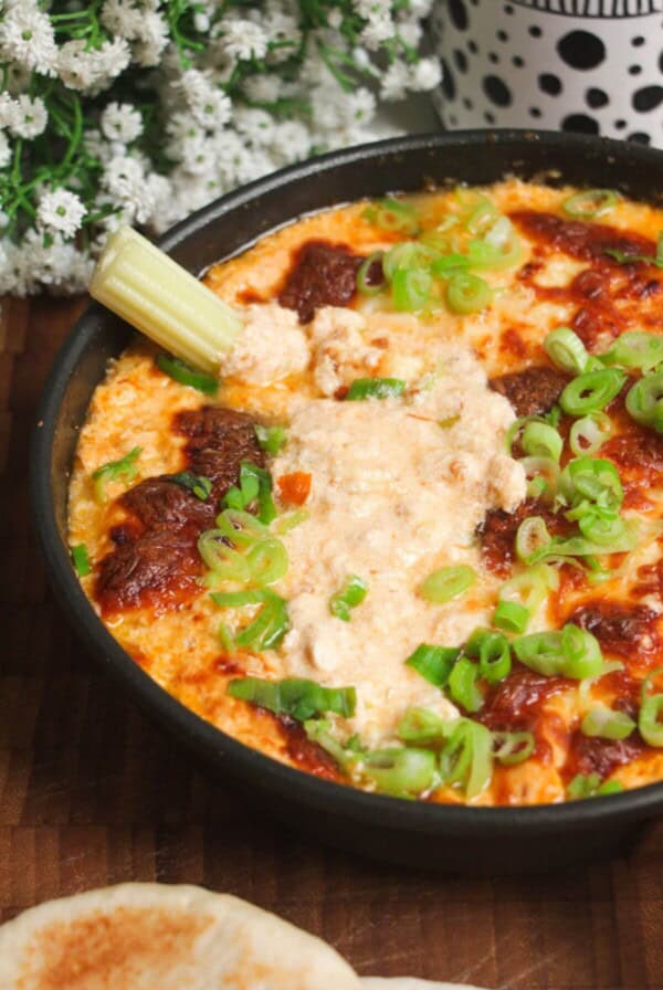 Buffalo chicken dip baked and topped with scallions.