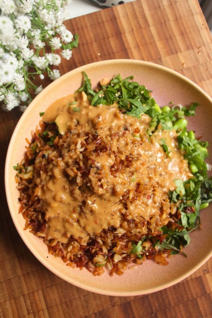 Satay sauce drizzled over crispy rice salad.