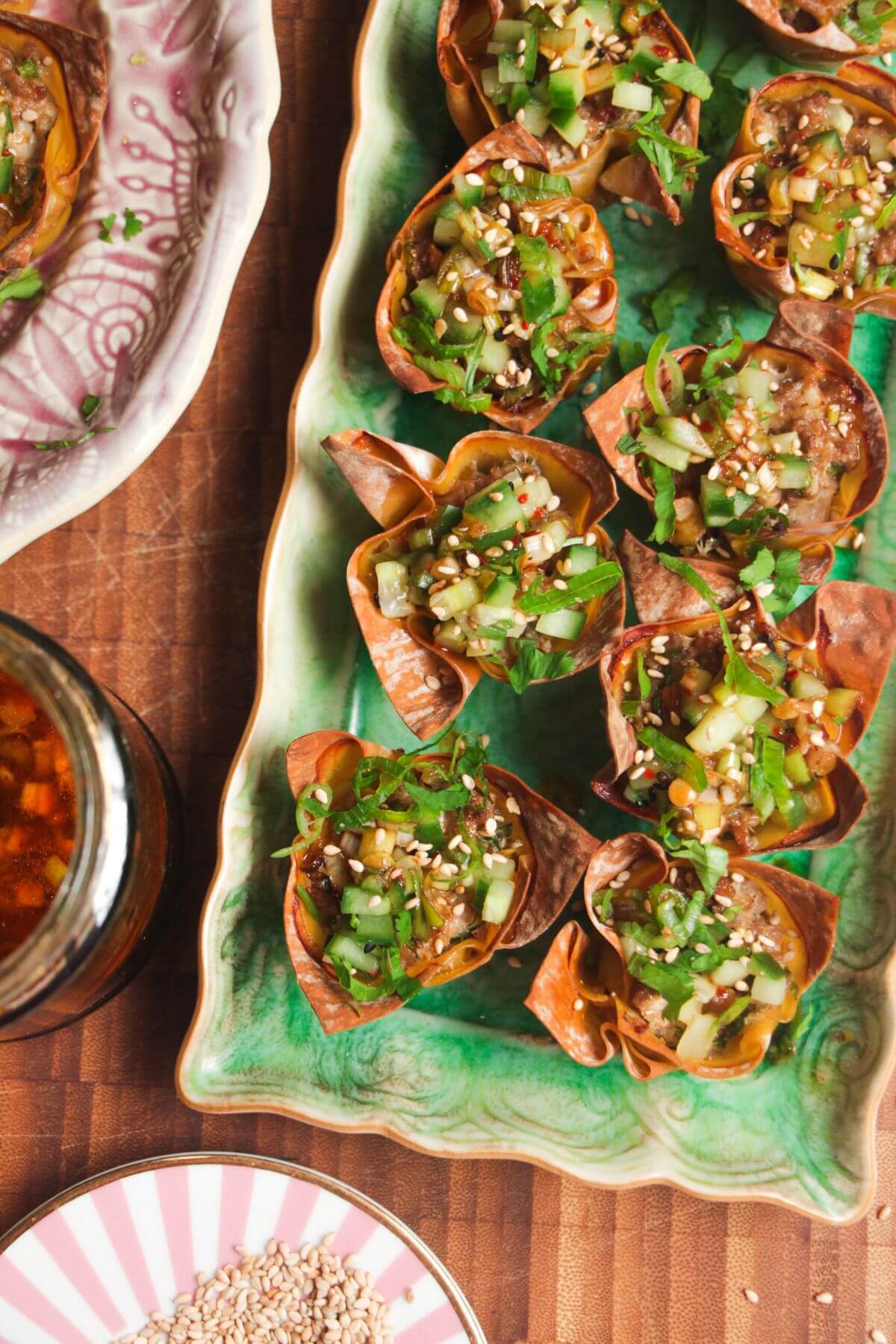 Mini dumpling cups on a green plate.