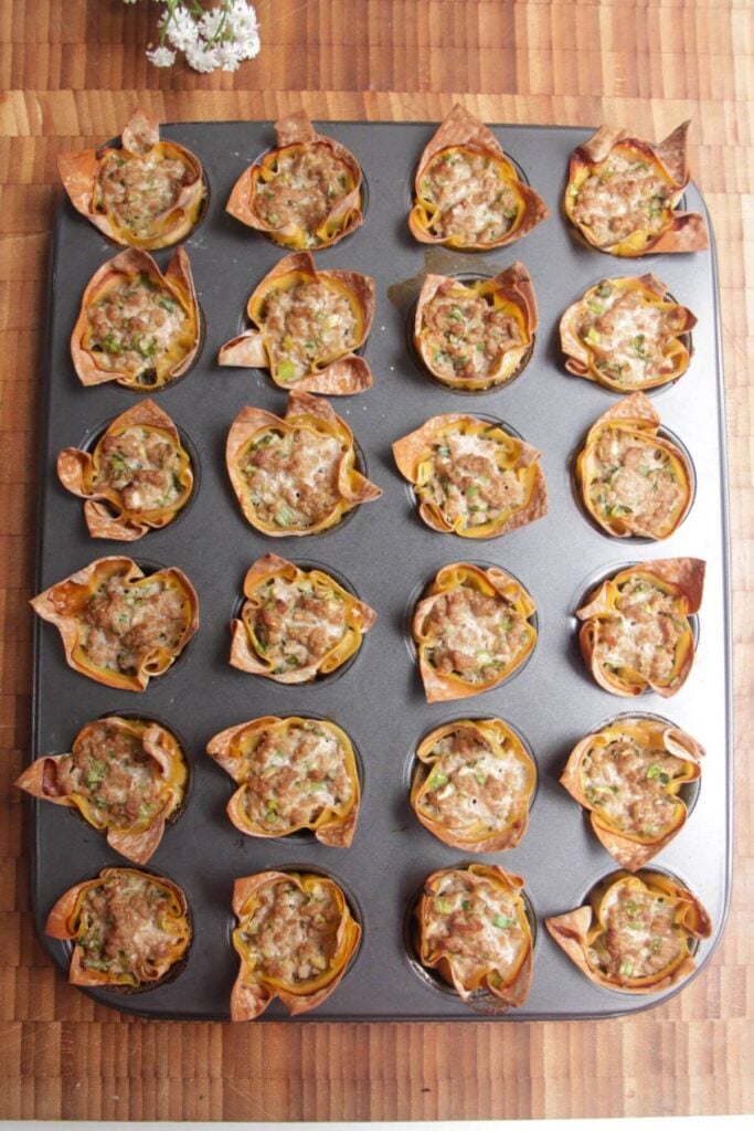 Baked dumpling cups in a mini muffin tin.