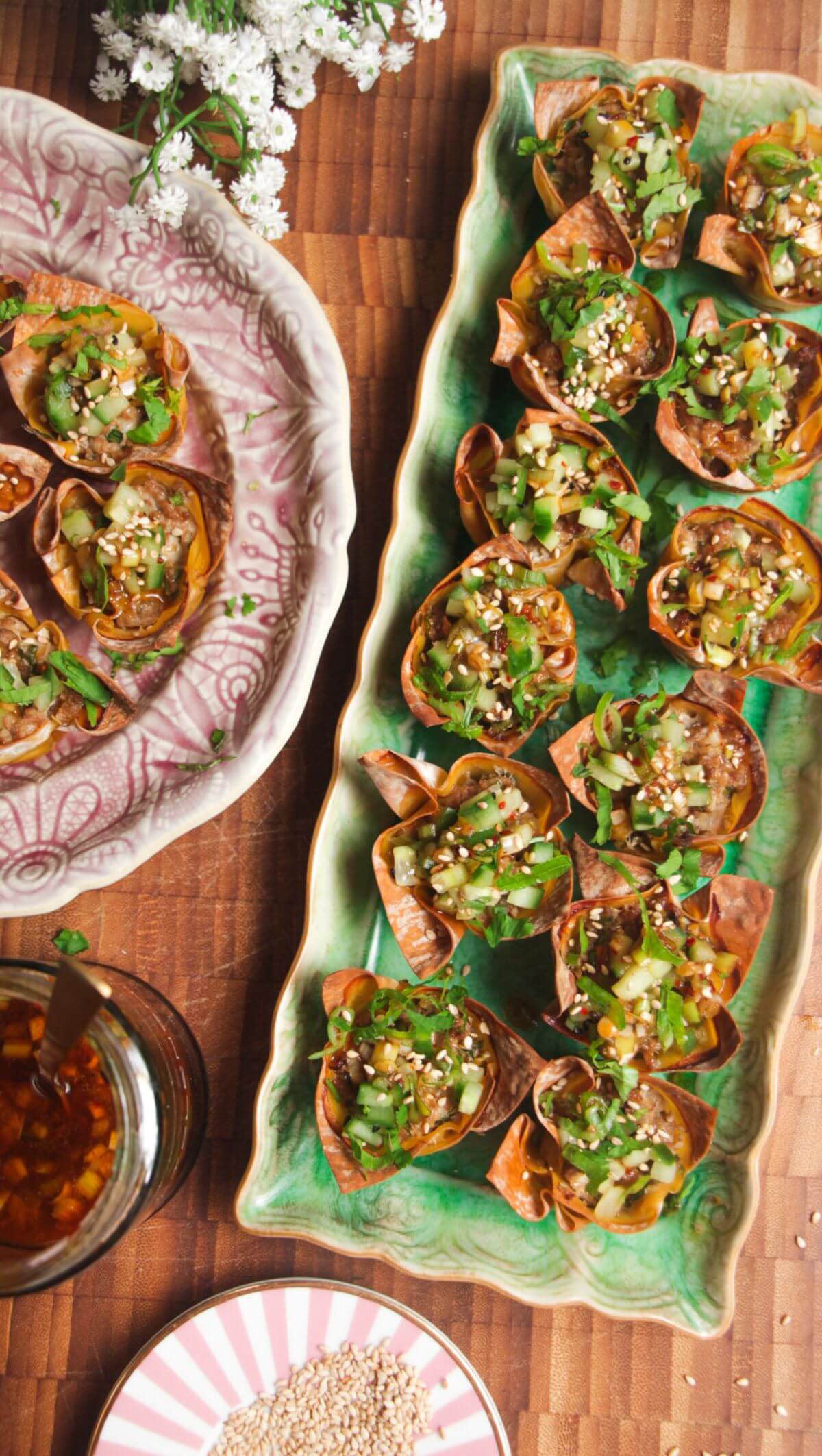 Mini dumpling cups on a green plate.