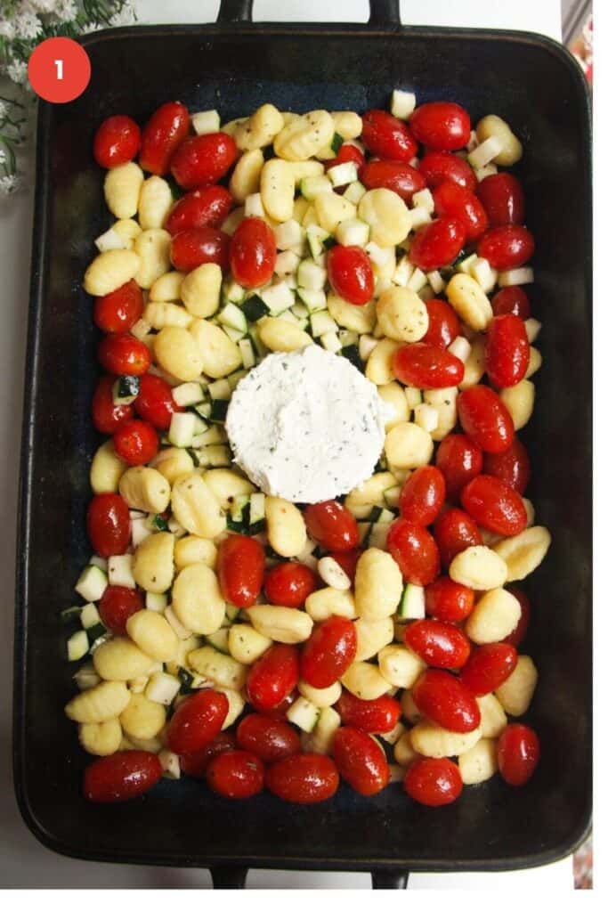 Gnocchi, tomatoes, zucchini and Boursin in baking dish.