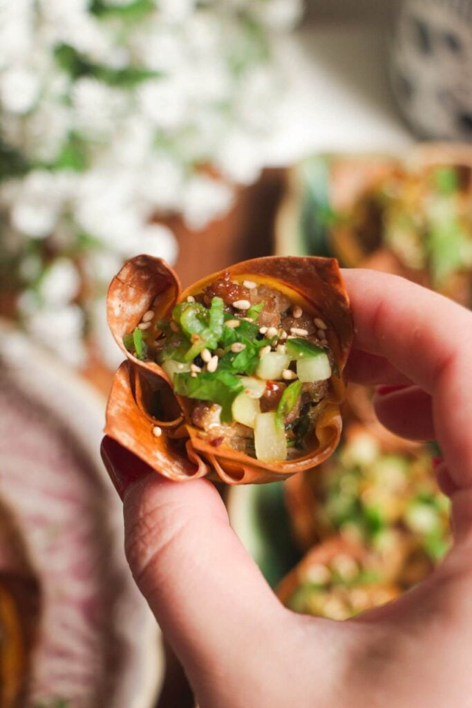 Hand holding a mini dumpling bite.