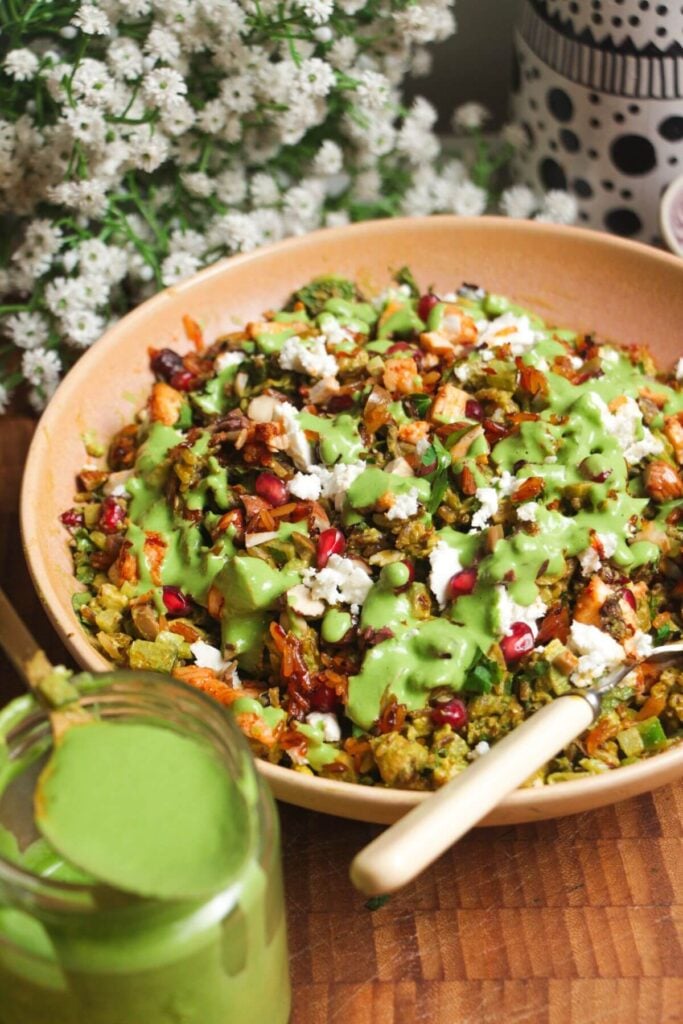 Mediterranean crispy rice salad in a pink bowl.