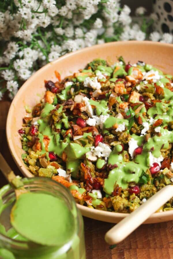 Mediterranean crispy rice salad in a pink bowl.
