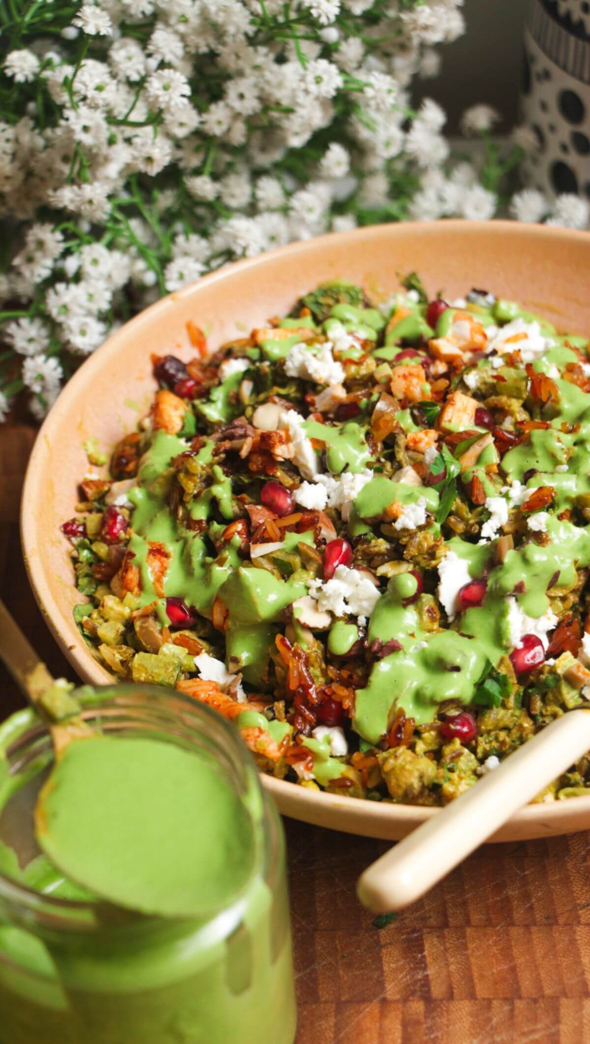 Mediterranean crispy rice salad in a pink bowl.
