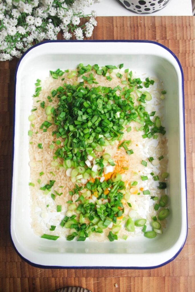 Rice, seasoning and herbs in a white tin.