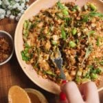 Satay crispy rice salad in a pink bowl.