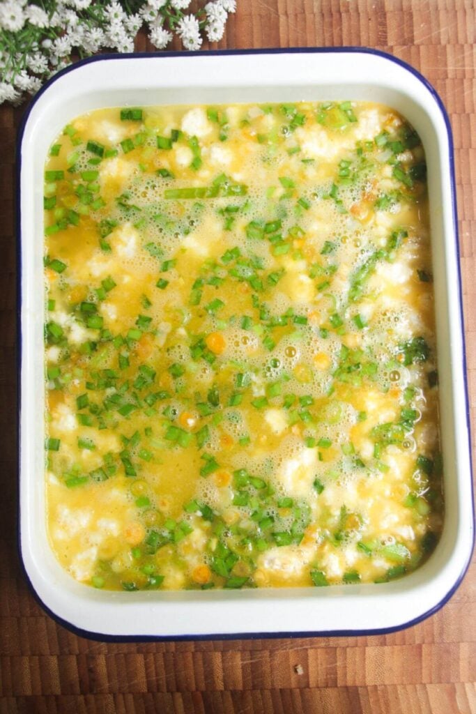 Stock on top of loaded rice in a white tin.