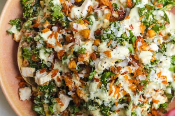 Chicken Caesar rice salad in a pink bowl.