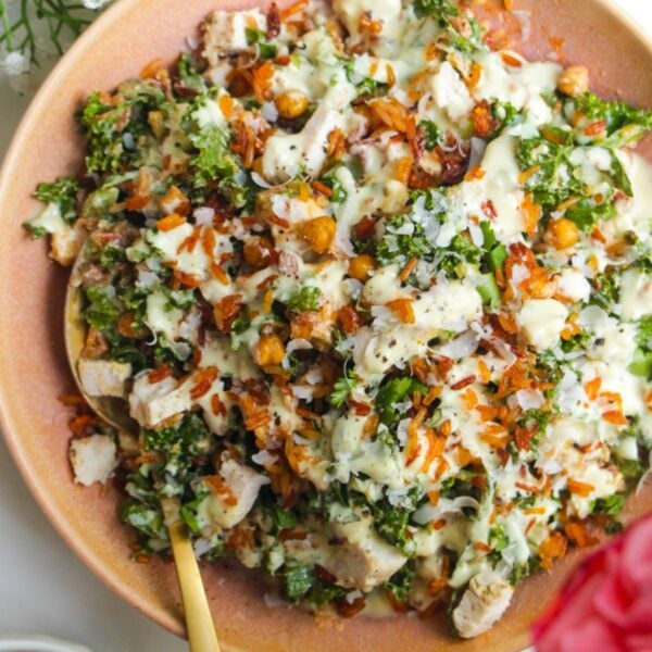 Chicken Caesar rice salad in a pink bowl.