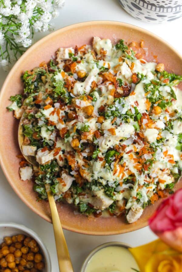 Chicken Caesar rice salad in a pink bowl.