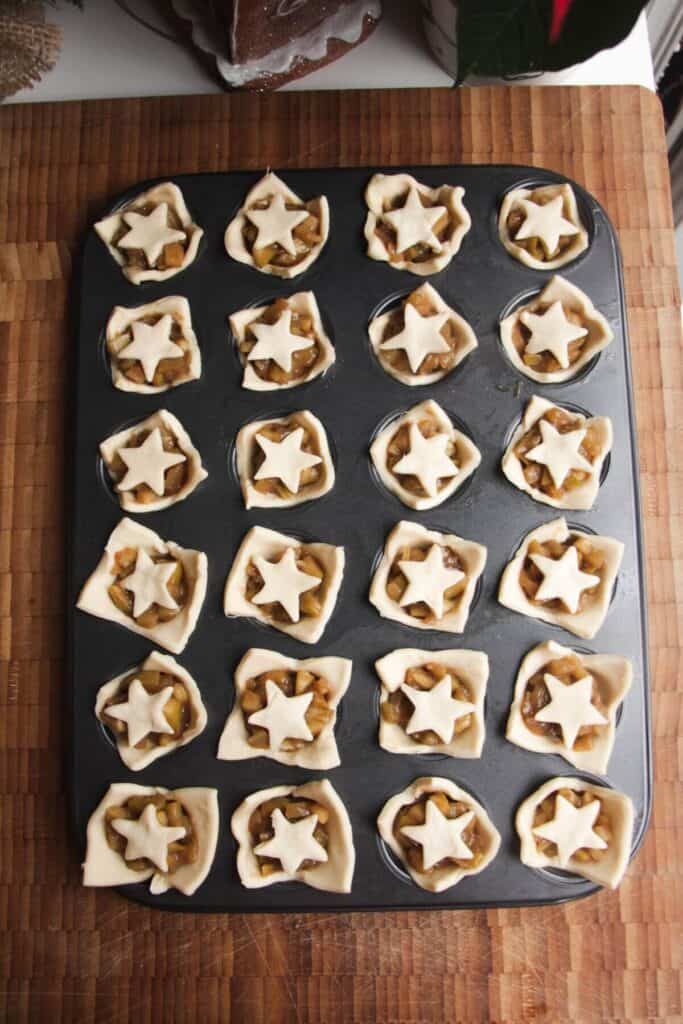 Apple pie bites uncooked in a mini muffin tin.
