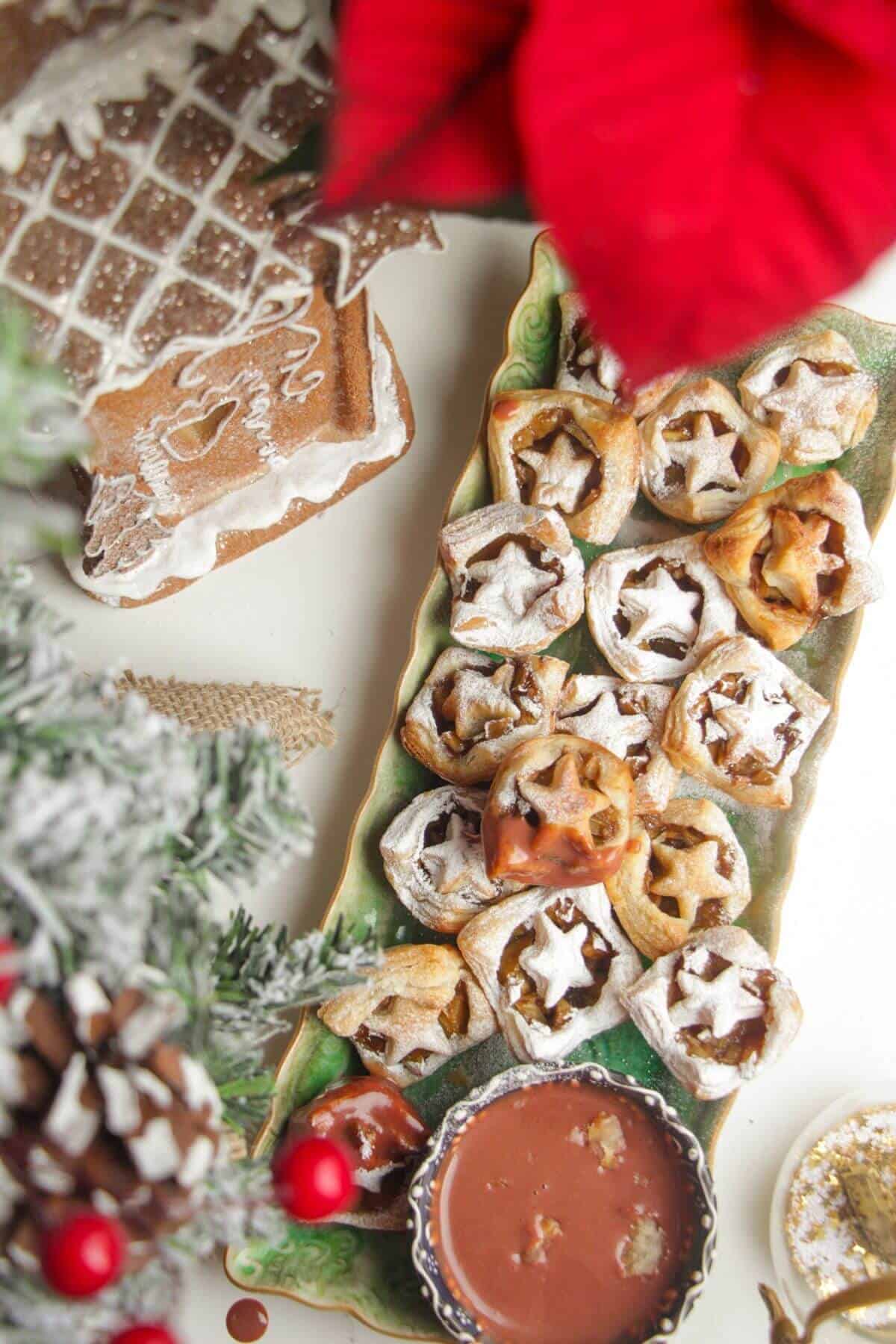 A platter of mini apple pie bites dusted with icing sugar.
