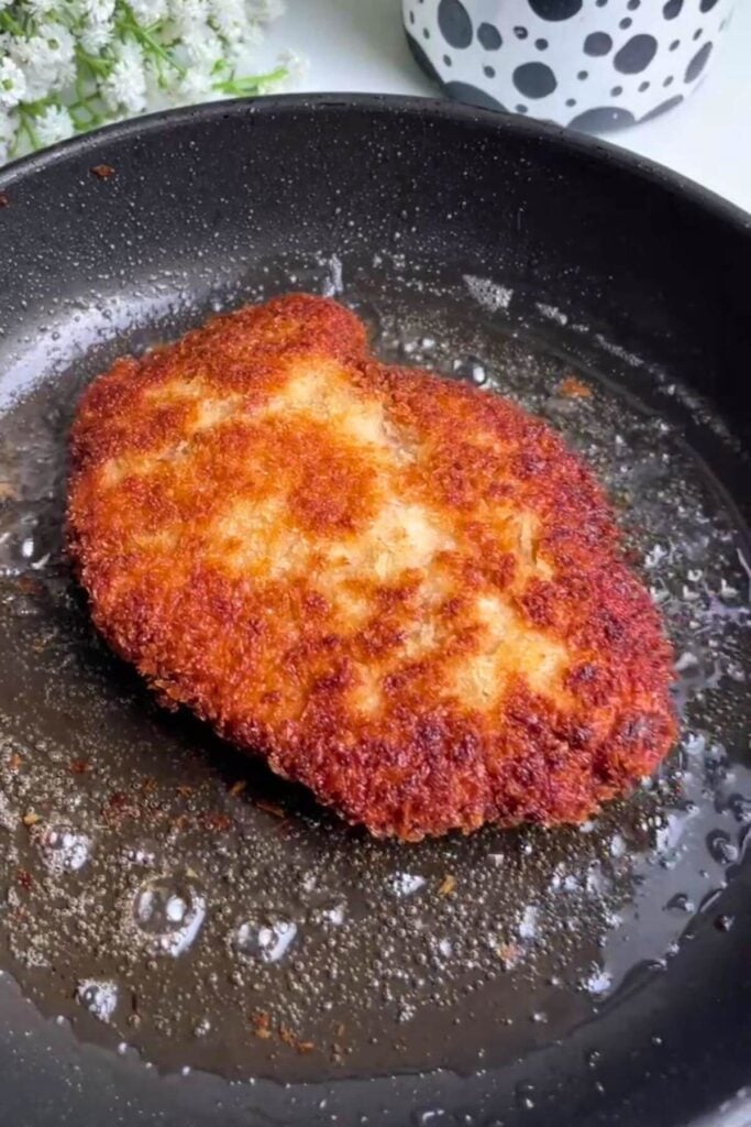 Crispy breaded chicken in a small pan.