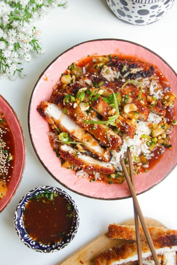 Crispy sweet and sour chicken in a bowl with rice.