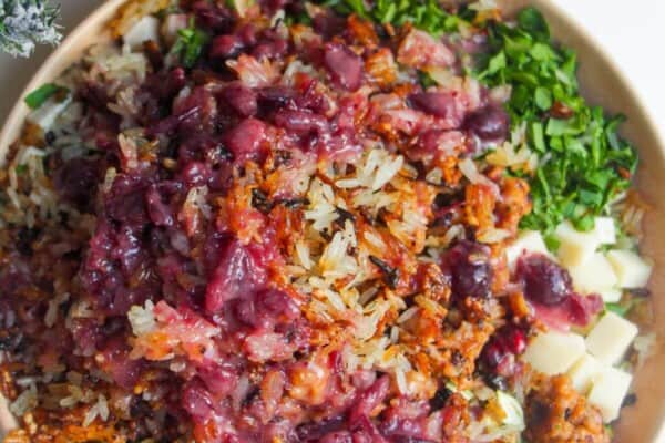 Cranberry dressing poured over crispy rice salad.
