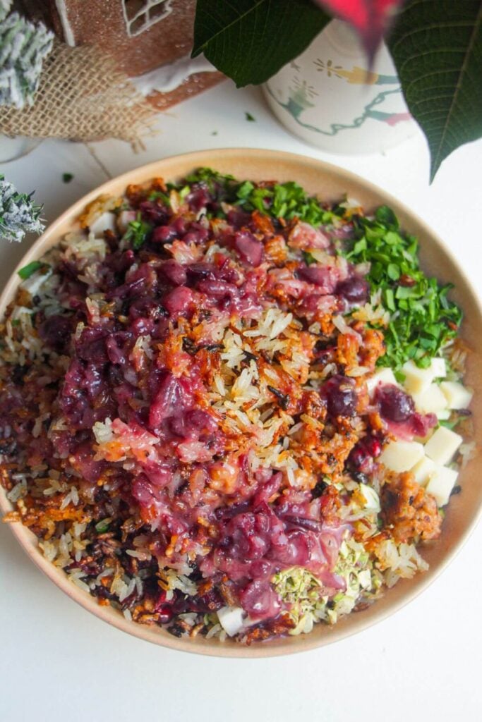 Cranberry dressing poured over crispy rice salad.