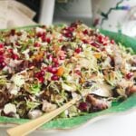 Festive crispy rice salad on a large green platter.
