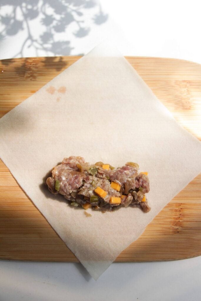 Cheeseburger filling on spring roll wrapper.