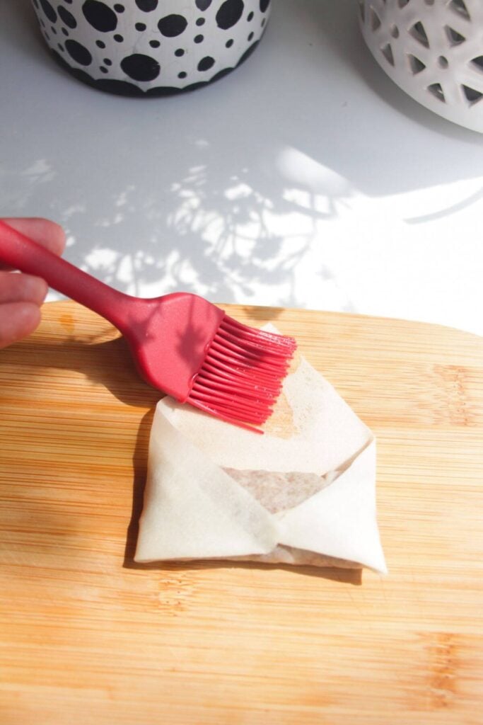 Brushing water on spring roll wrapper.