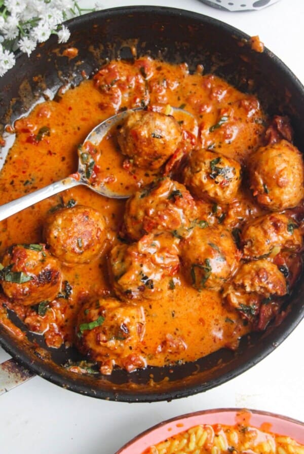 'Marry Me' chicken meatballs in sundried tomato sauce in a small pan.