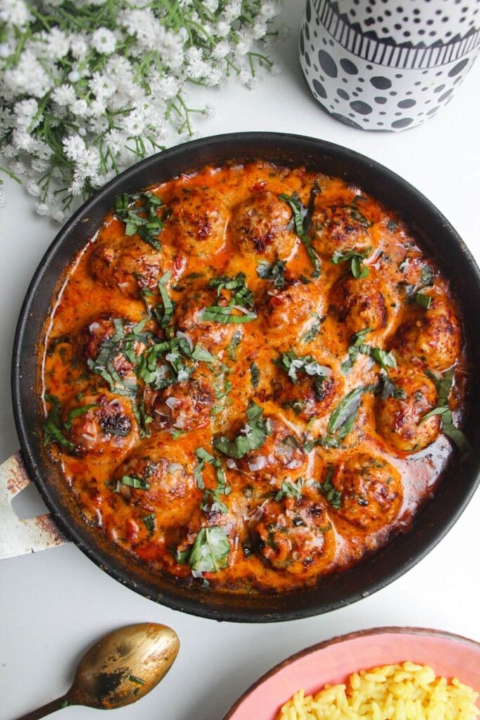 'Marry Me' chicken meatballs in a pan with rice on the side.