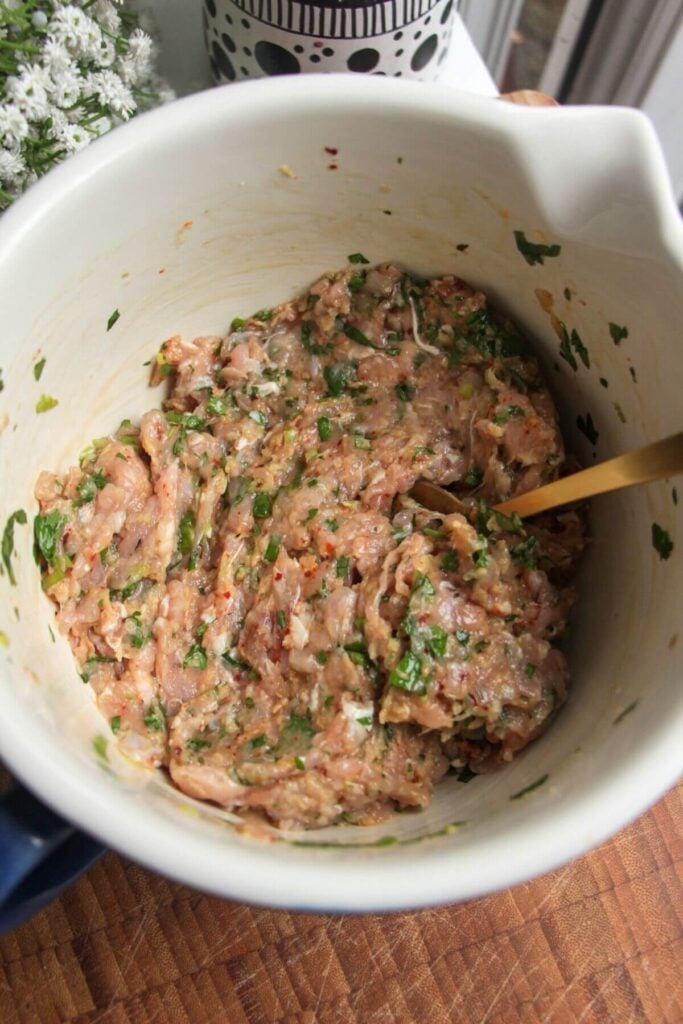 Chicken meatball mix in a small bowl.