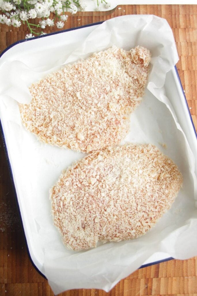Panko crumbed chicken breasts in a dish.