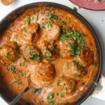 Chicken meatballs in a satay sauce, topped with cilantro and scallions.