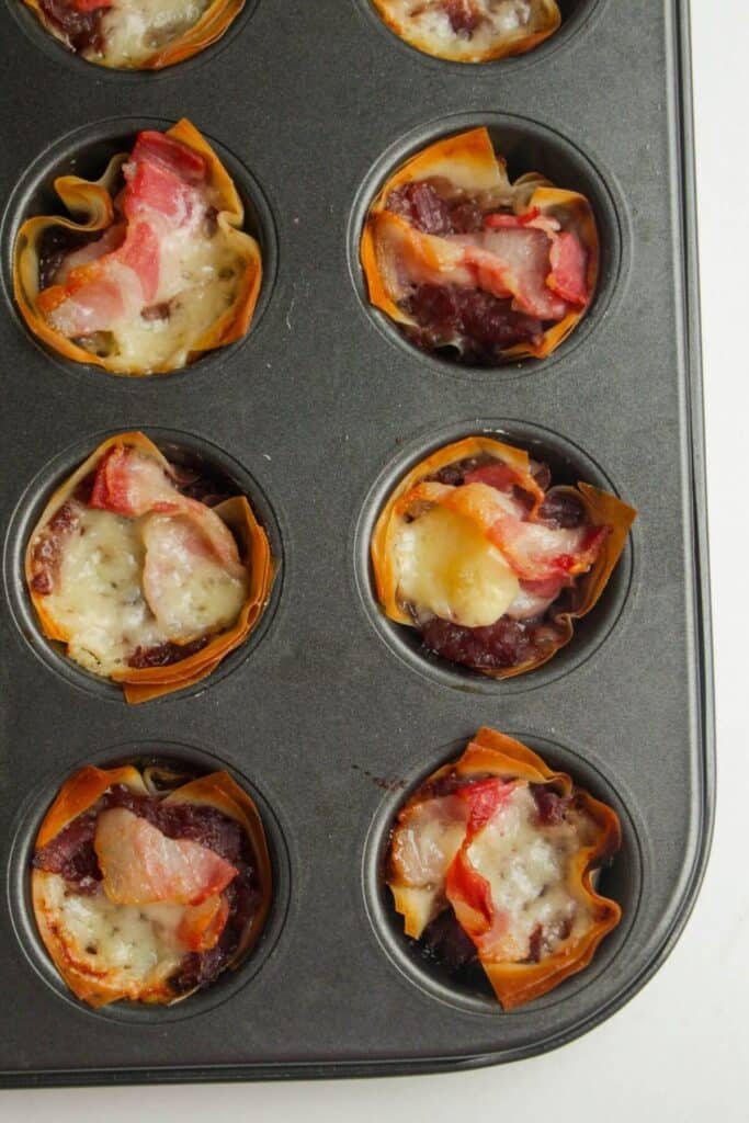 Close up of mini filo bites in a muffin tin.