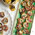 Caramelized onion filo bites on a green plate.