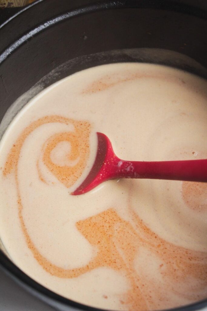 Coconut milk added to large pot.