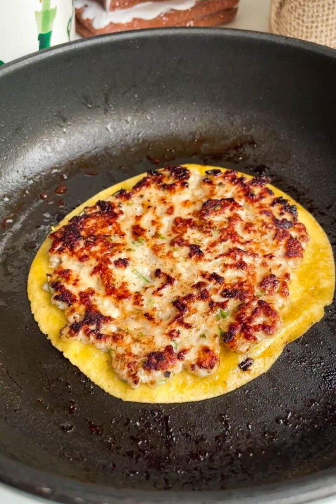 Festive smash taco cooked in a small pan.