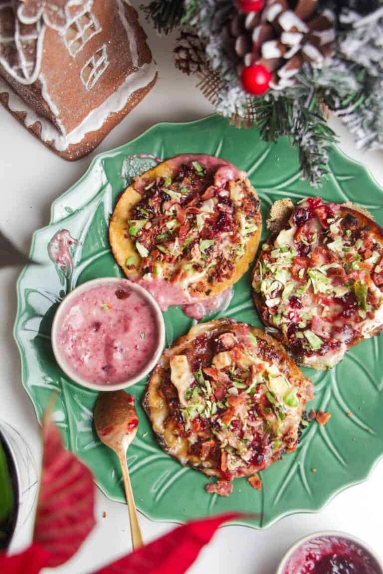 Three smash festive tacos on a green plate.