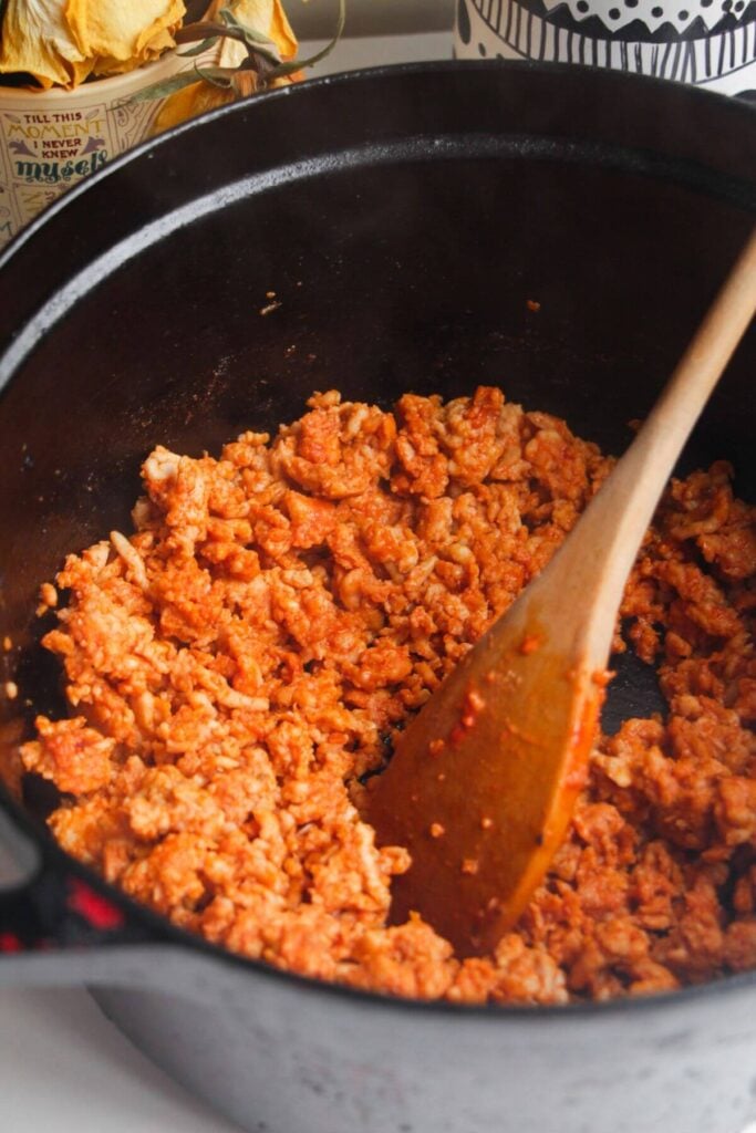 Ground chicken cooking with gochujang paste.