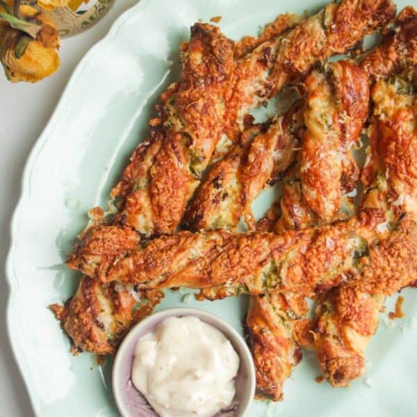 Cheese jalapeno popper straws on a blue plate.