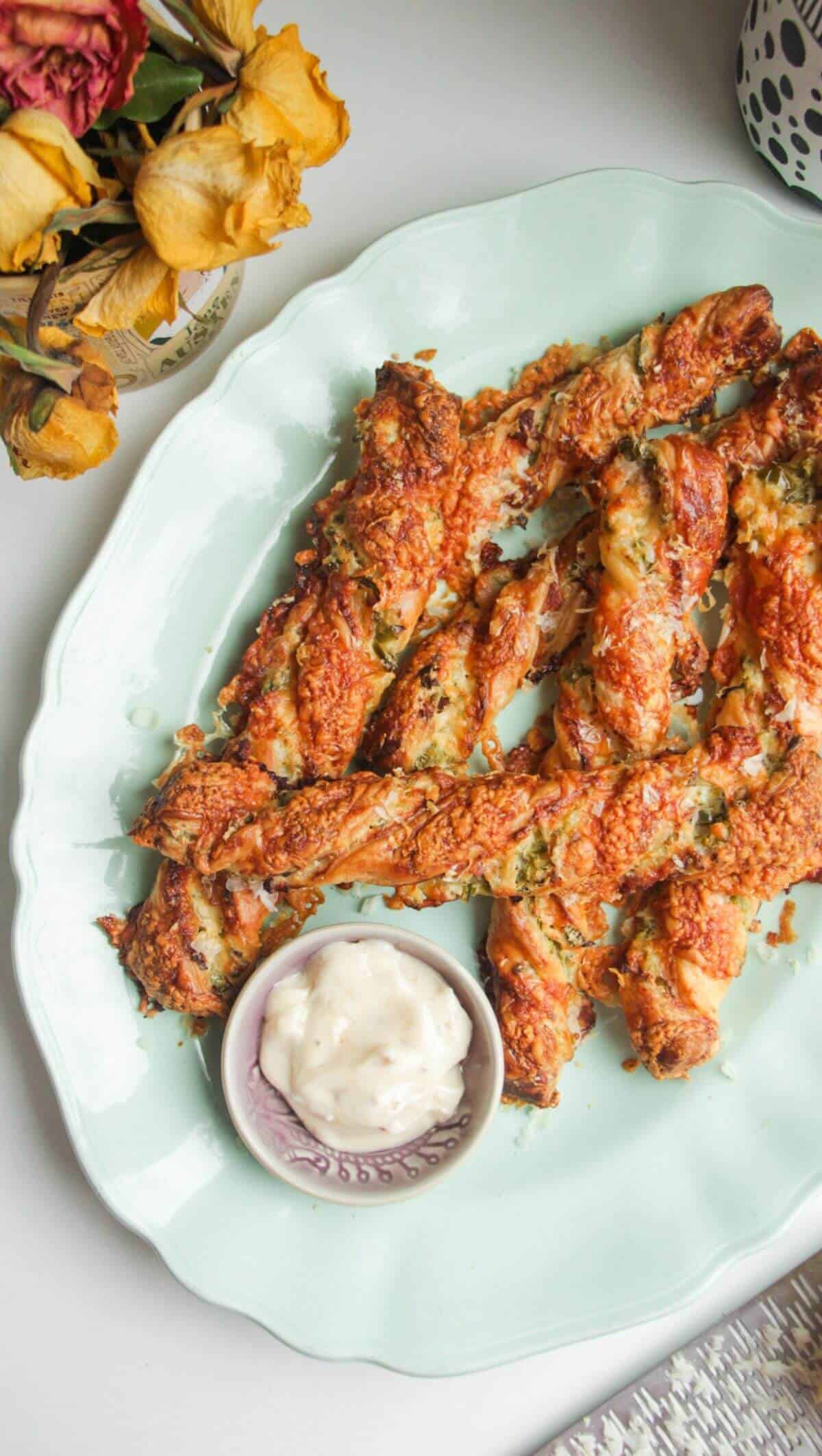Cheese jalapeno popper straws on a blue plate.