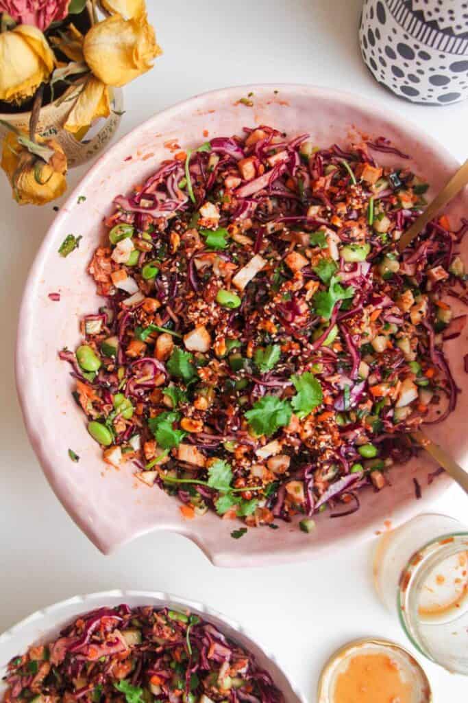 Korean grilled chicken crispy rice salad in a large pink bowl.