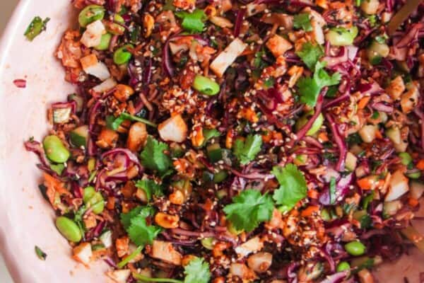 Korean grilled chicken crispy rice salad in a large pink bowl.