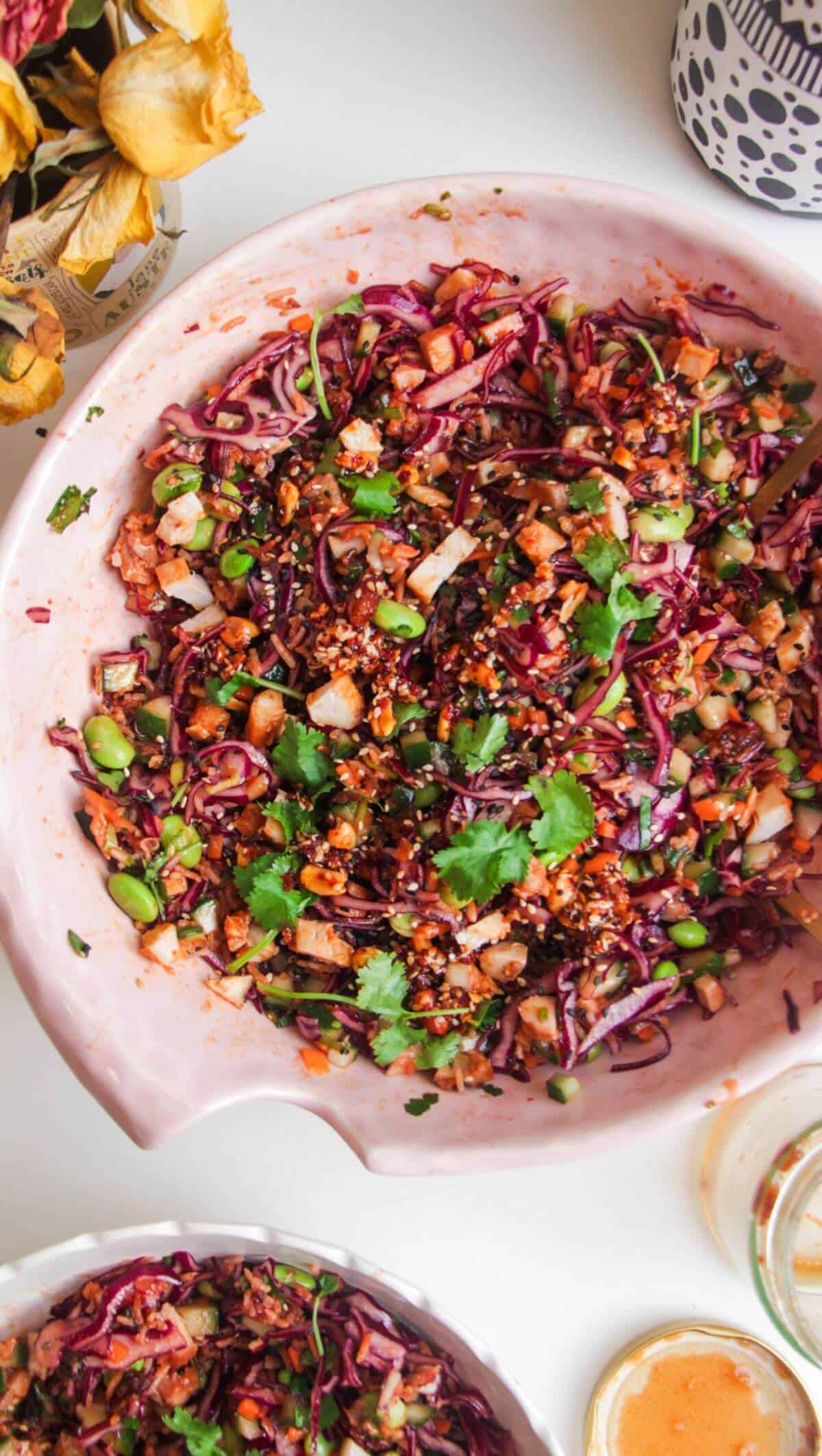 Korean grilled chicken crispy rice salad in a large pink bowl.