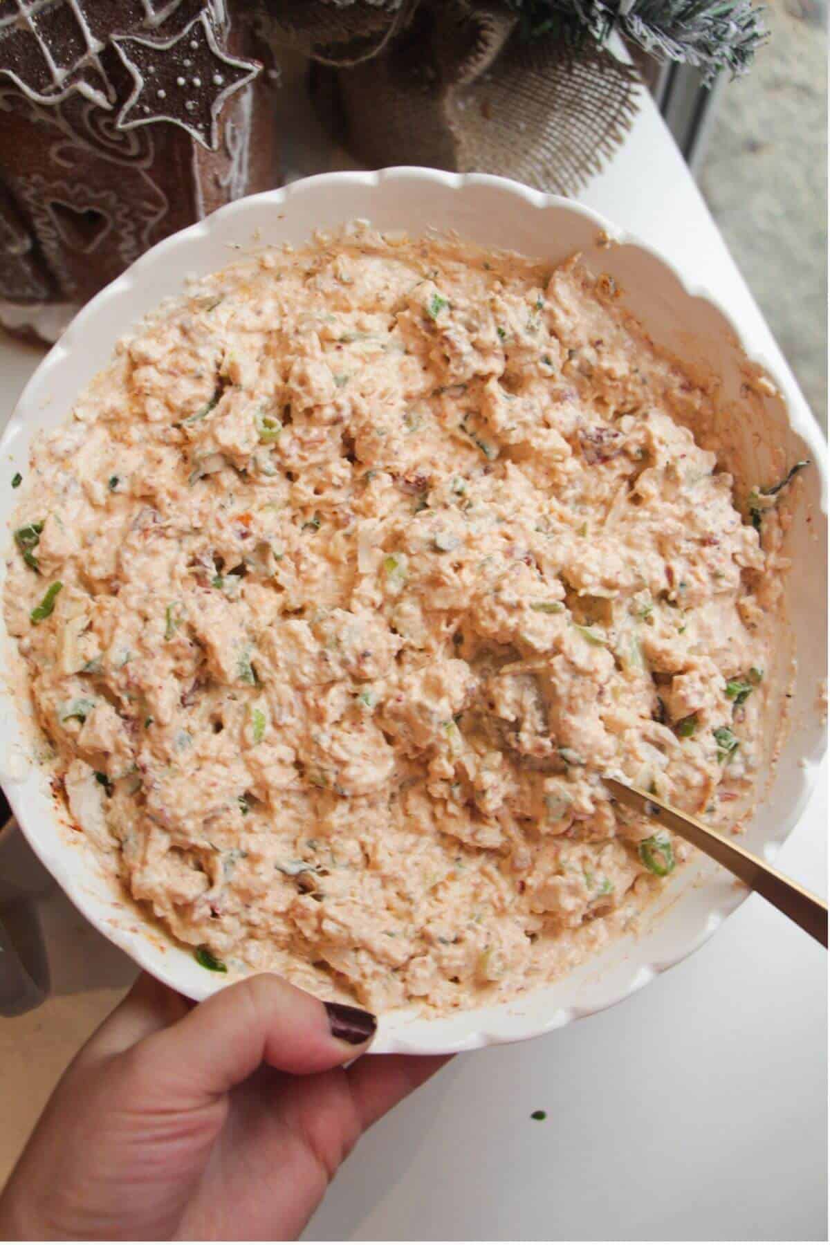 Marry me chicken dip ingredients mixed in a bowl.