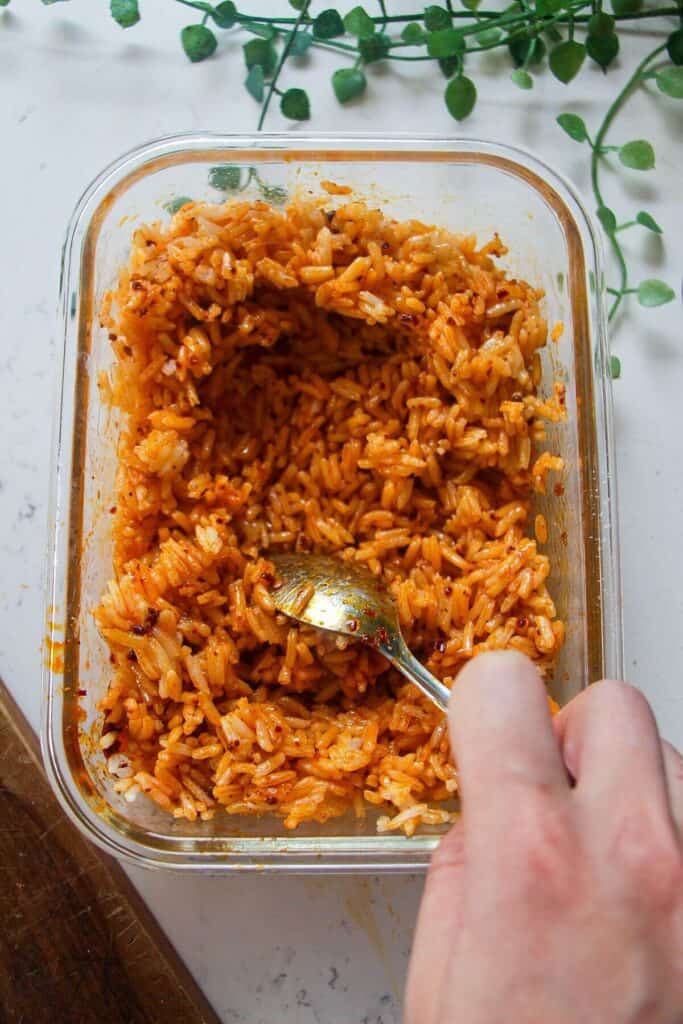 Mixing seasoning through rice.