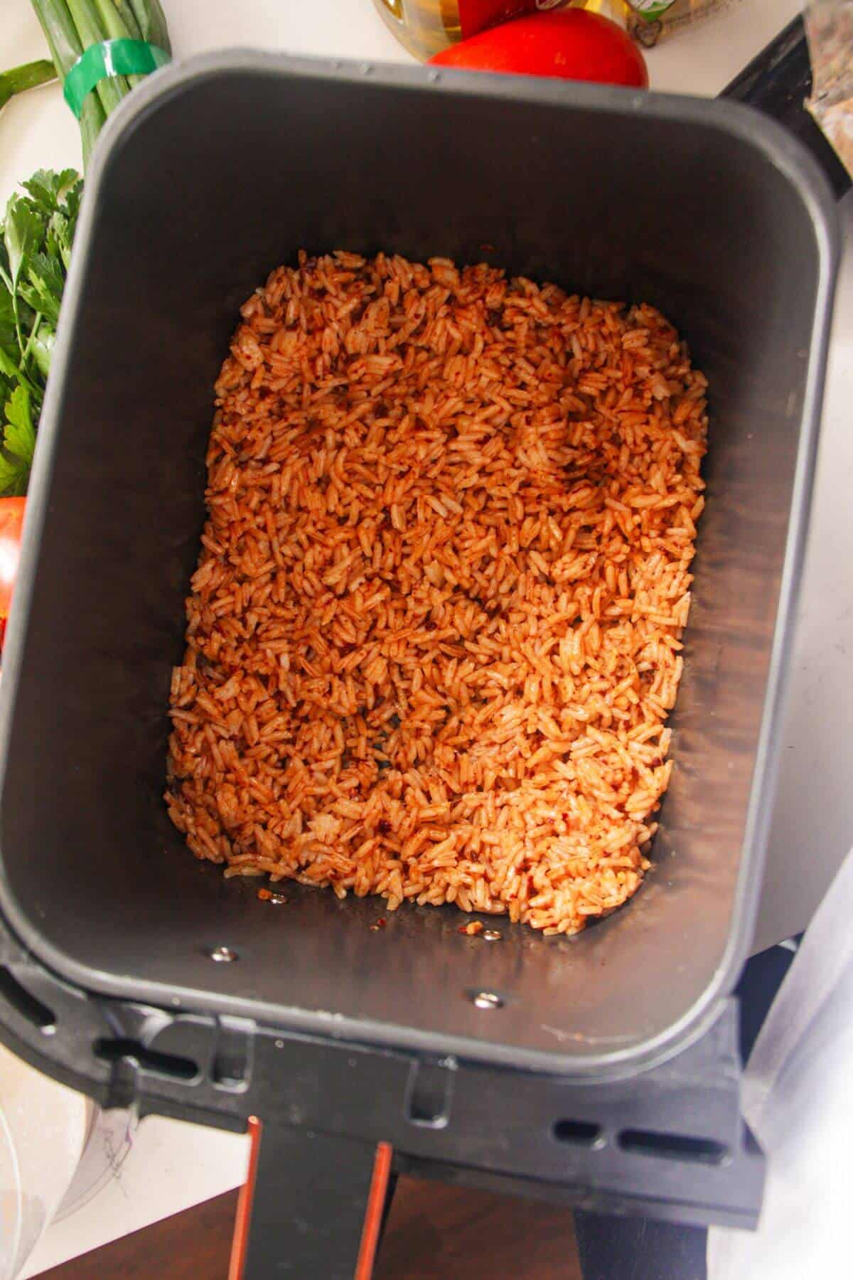 Rice in air fryer basket.