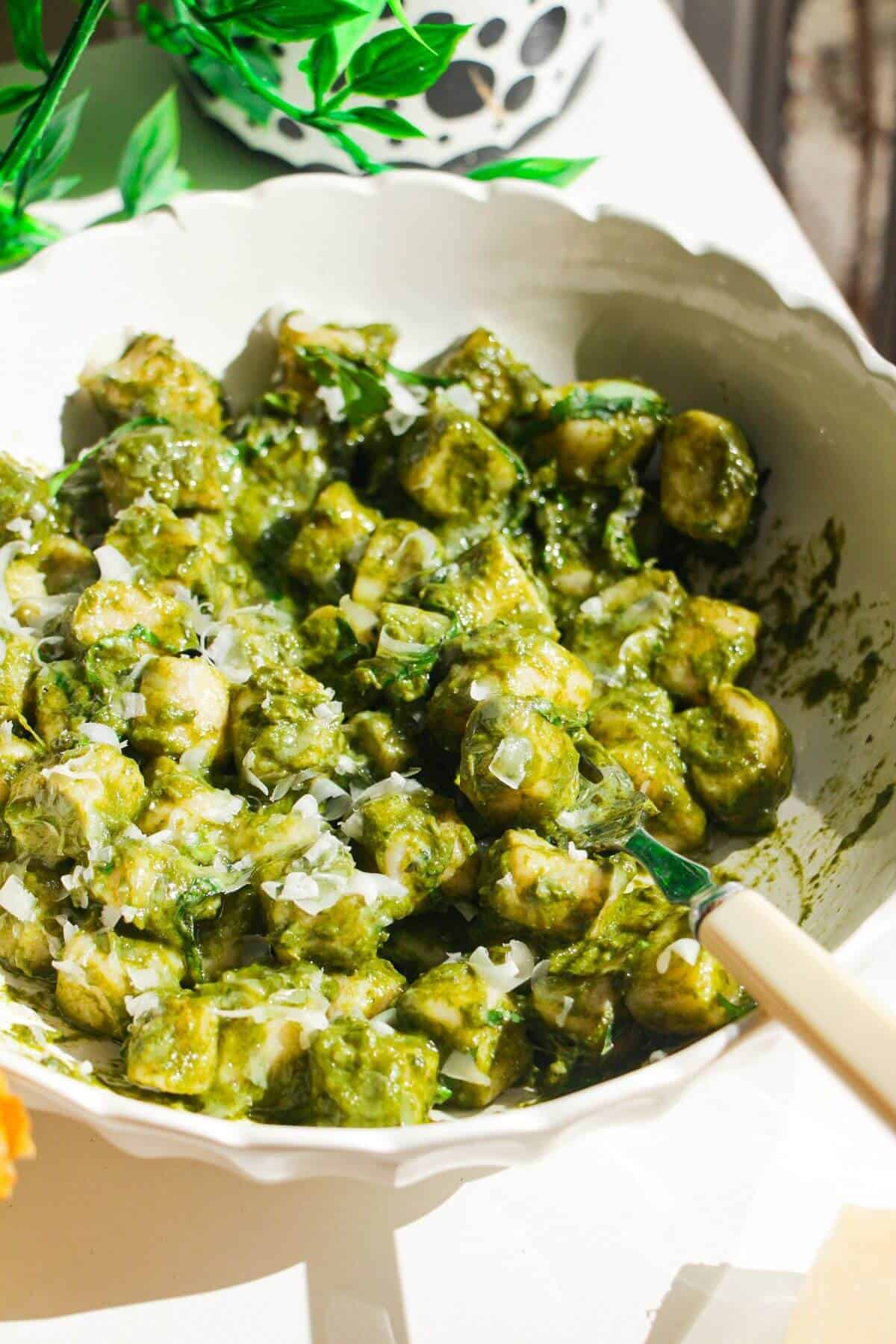 Cottage cheese gnocchi tossed with a green goddess sauce in a white bowl.