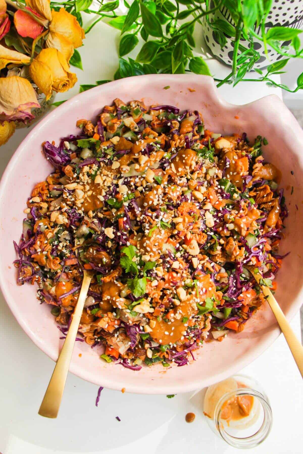 Crispy ramen salad served in a large pink bowl.