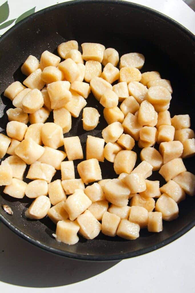 Cottage cheese gnocchi in a frying pan.