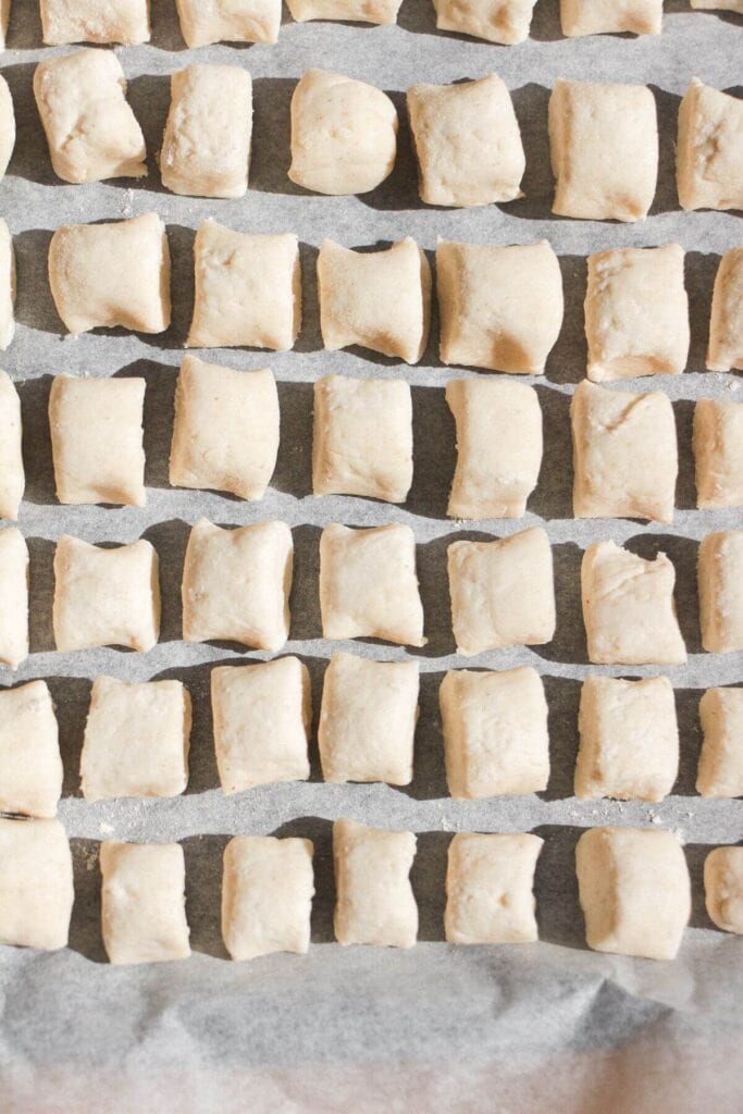 Cottage cheese gnocchi on a lined tray.